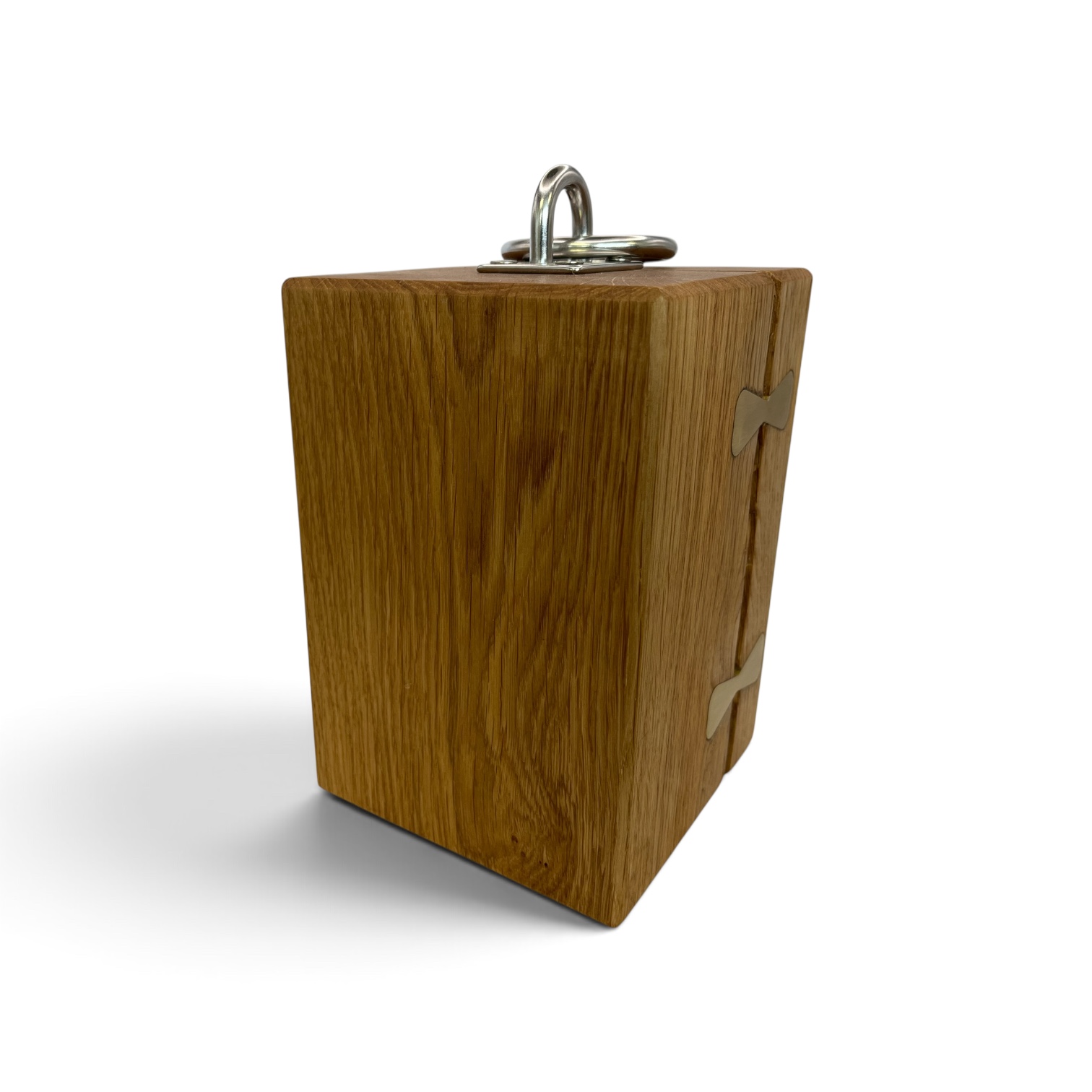 Solid oak doorstop with brass inlays holding together a large split and a chrome lifting handle on top.