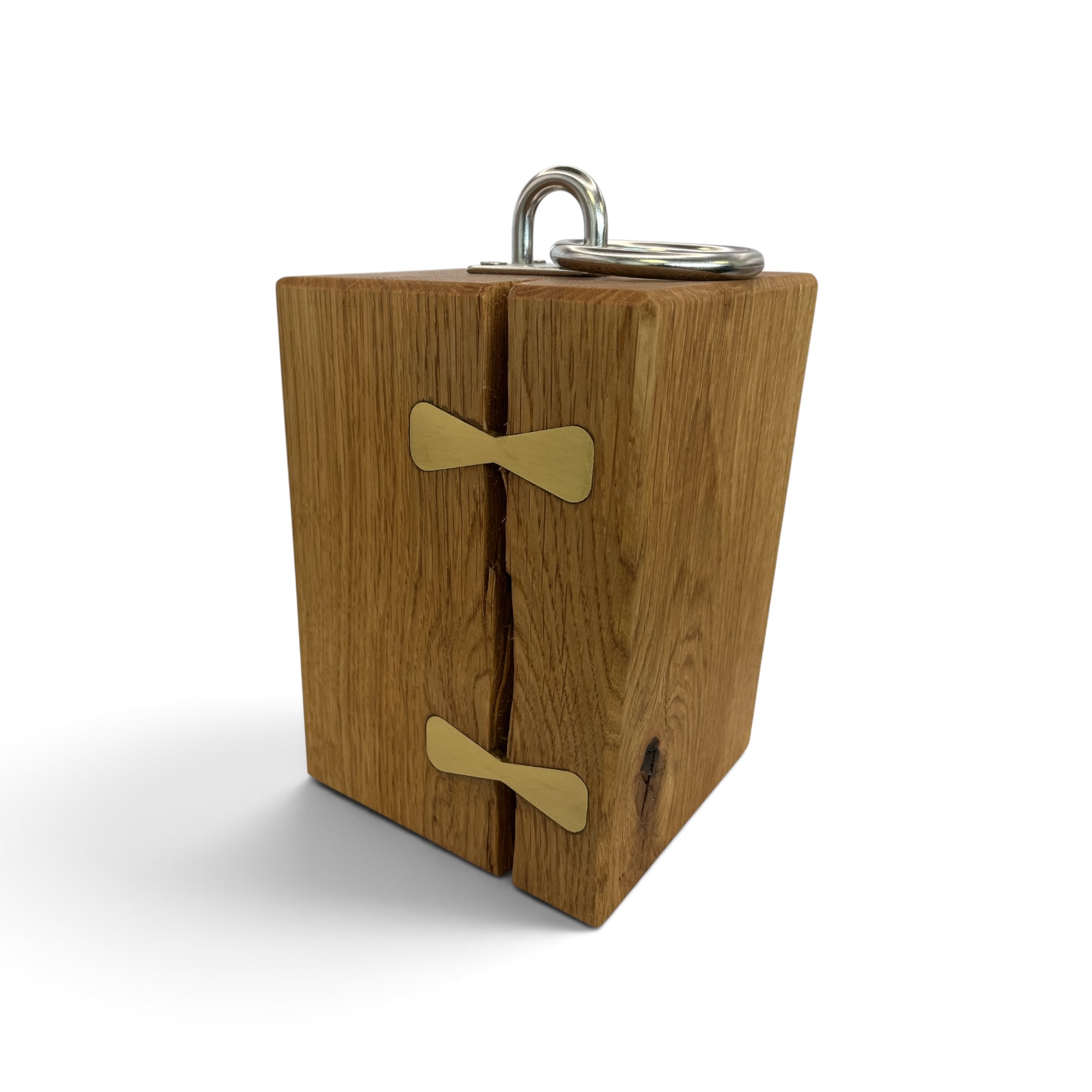 Solid oak doorstop with brass inlays holding together a large split and a chrome lifting handle on top.