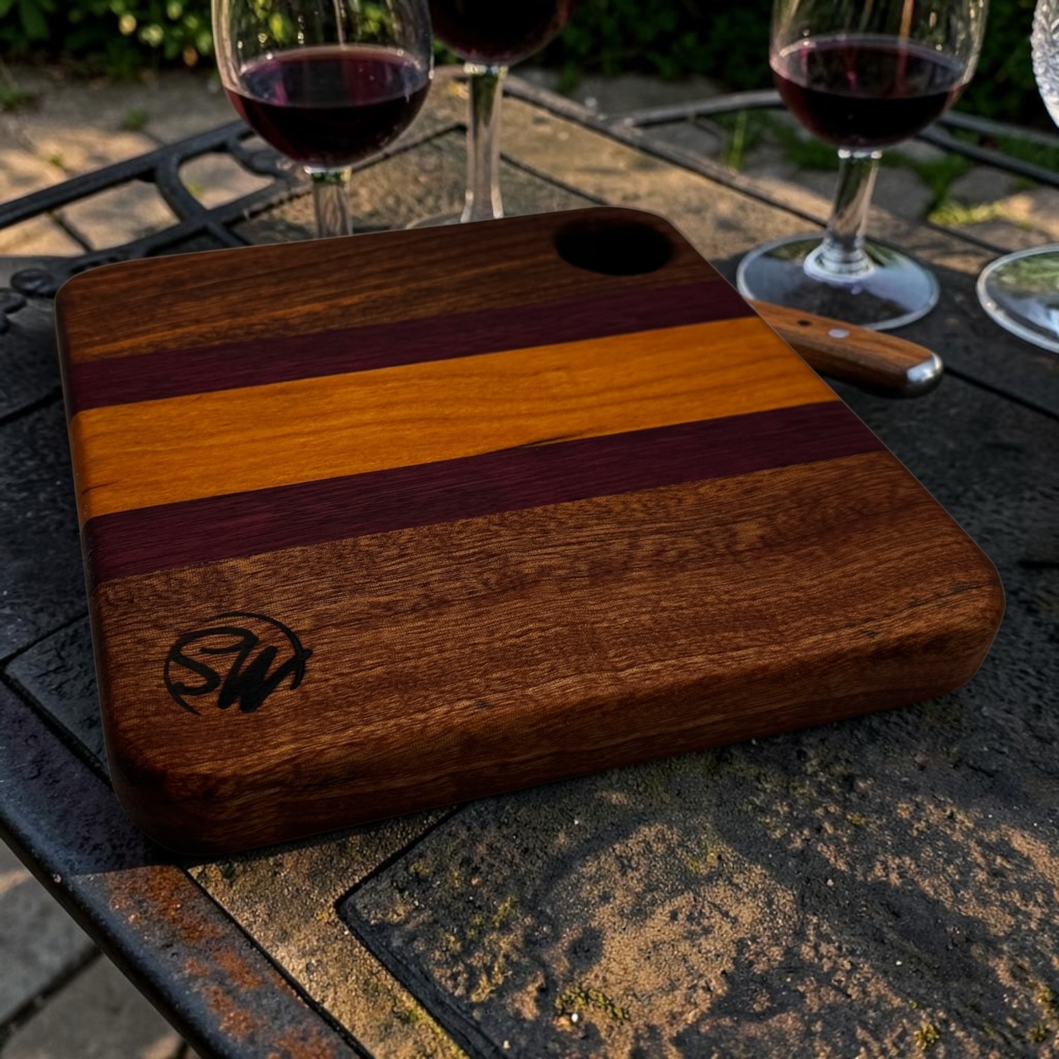 A gorgeous edge grain board next to wine.