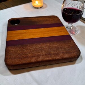 A gorgeous edge grain board next to a glass of port.