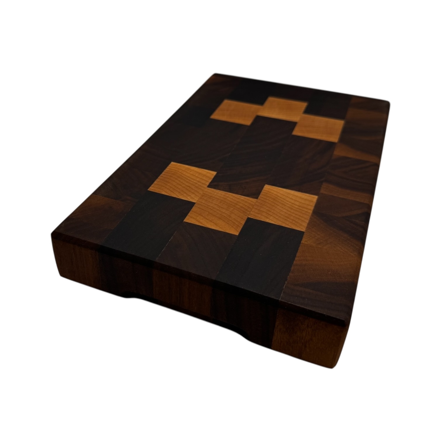 End grain chopping board made of walnut and maple with no background.