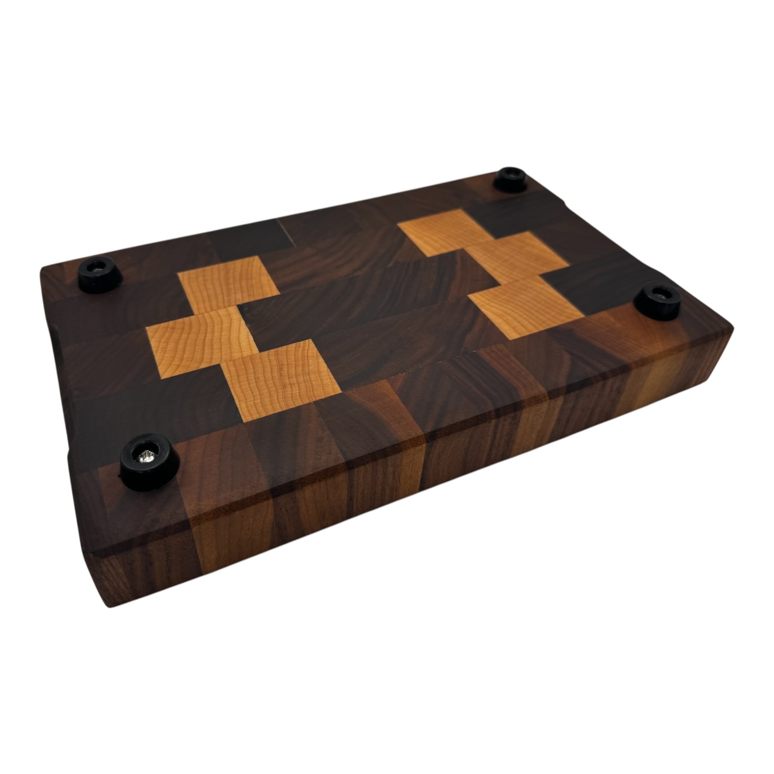 End grain chopping board made of walnut and maple showing feet with no background.