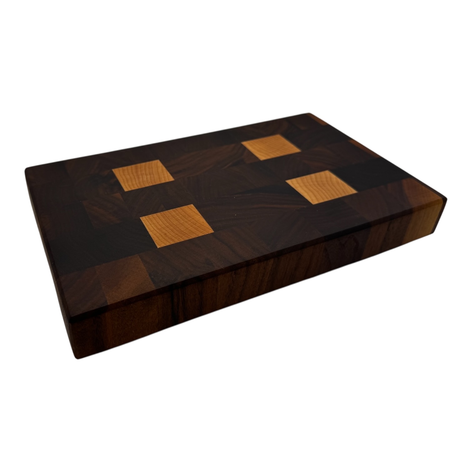 End grain chopping board made of walnut and maple with a square pattern and no background.